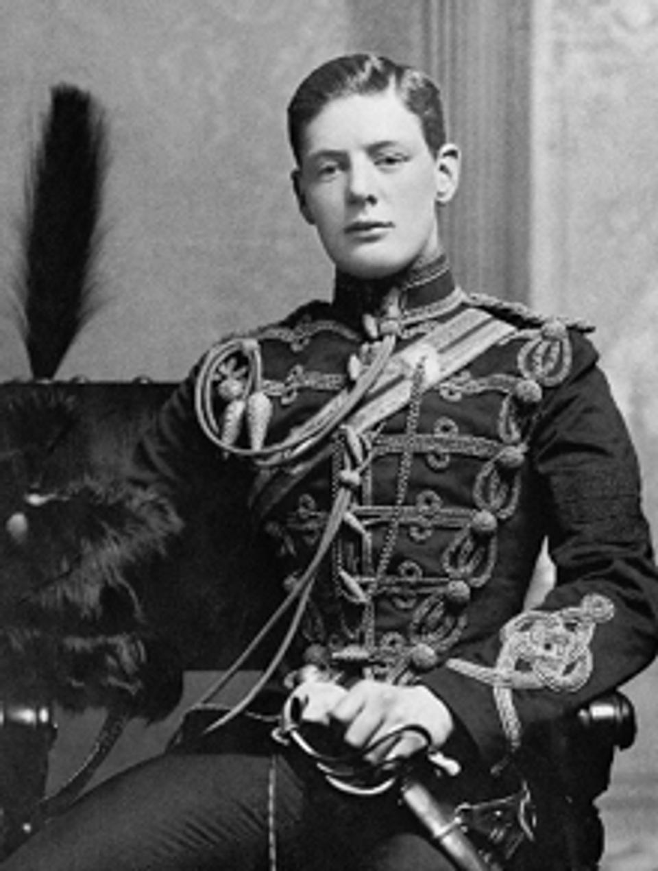Young Winston Churchill posing in his military dress uniform.