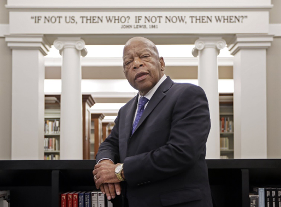 John Lewis poses for a photo under a quote of his that is displayed in the Civil Rights Room in the Nashville Public Library.
