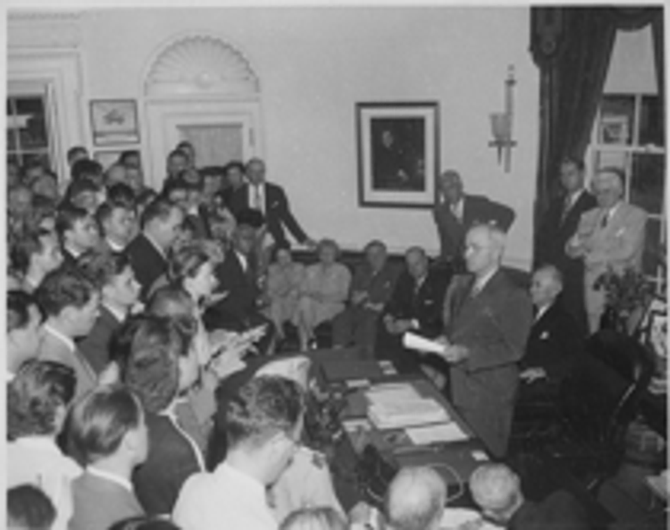 A photograph of President Truman announcing Japan’s surrender.