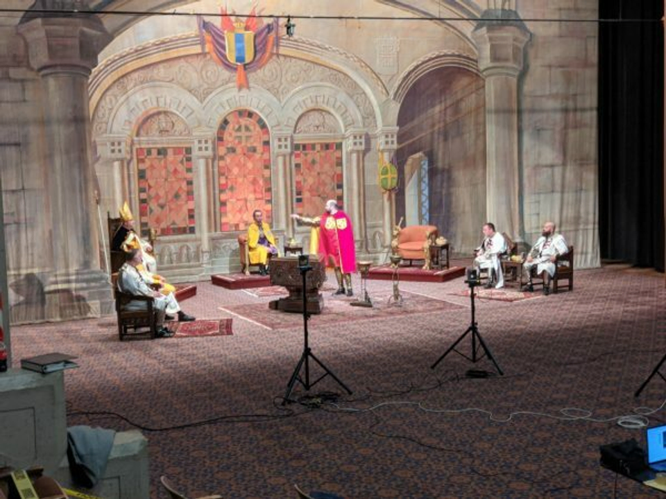 Scottish Rite Masons act out a scene on a temple set